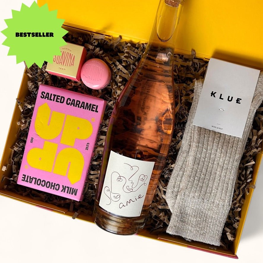 Ready to go gift box with rose wine, chocolate, socks and scented candle