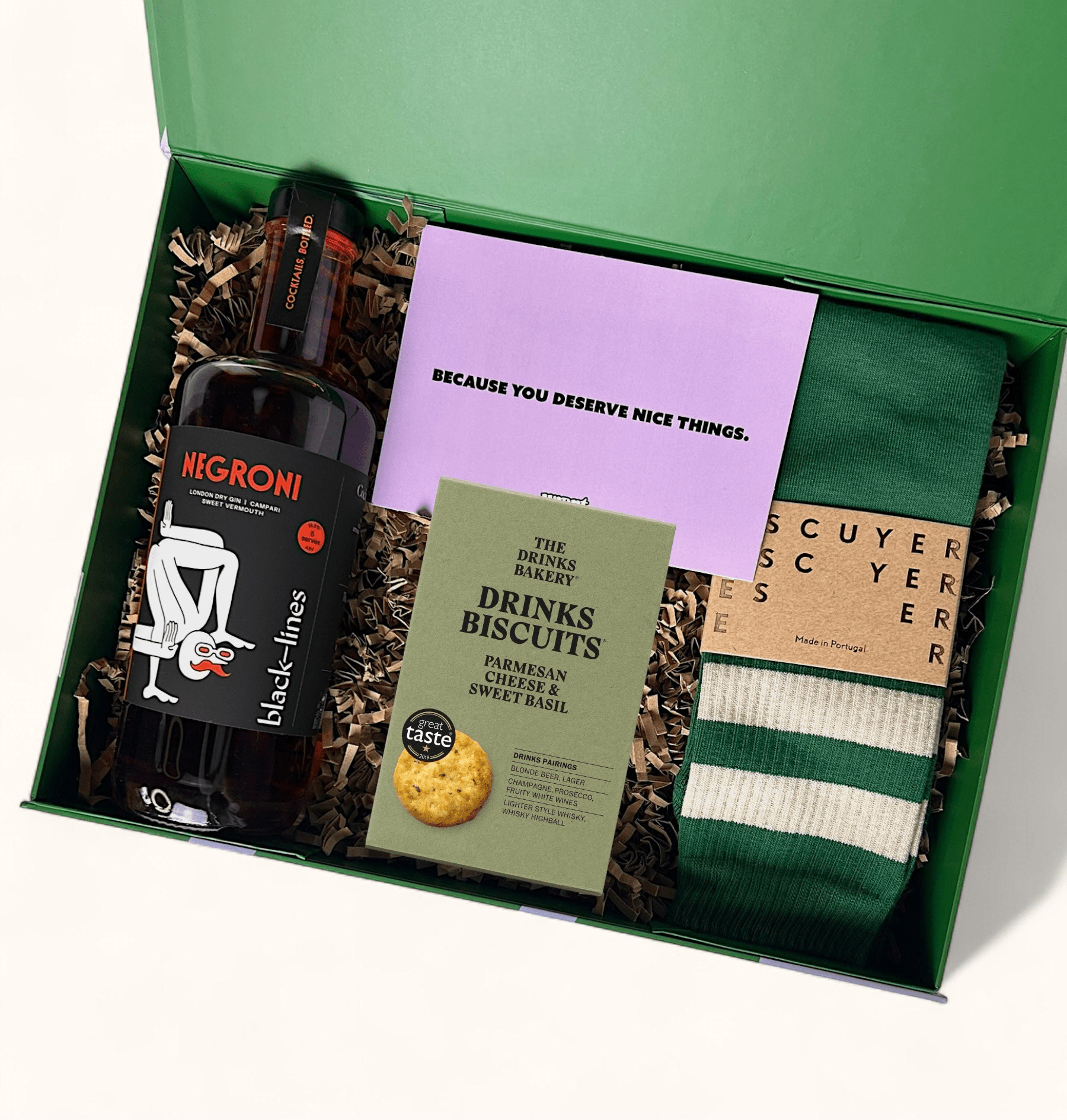 Ready to go gift box with large bottle of negroni, savoury drinking biscuits and green retro socks