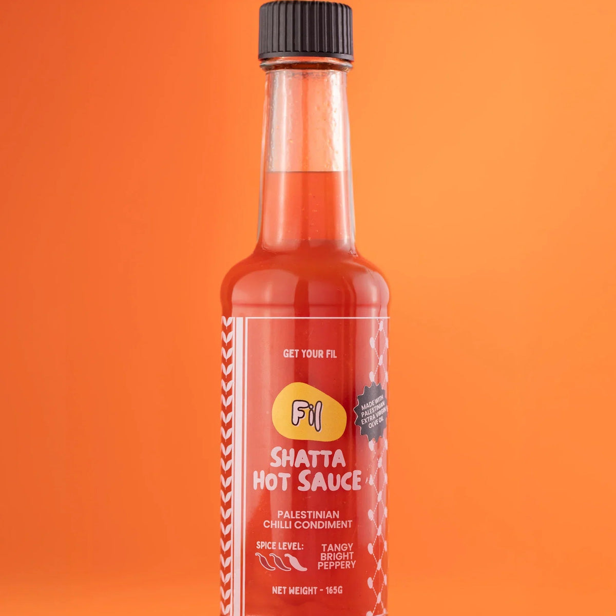 Bottle of Fil Shatta Hot Sauce on a white background